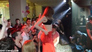 Lady in red slowly strips naked on stage during a live concert