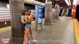 Three young women posing on a subway train